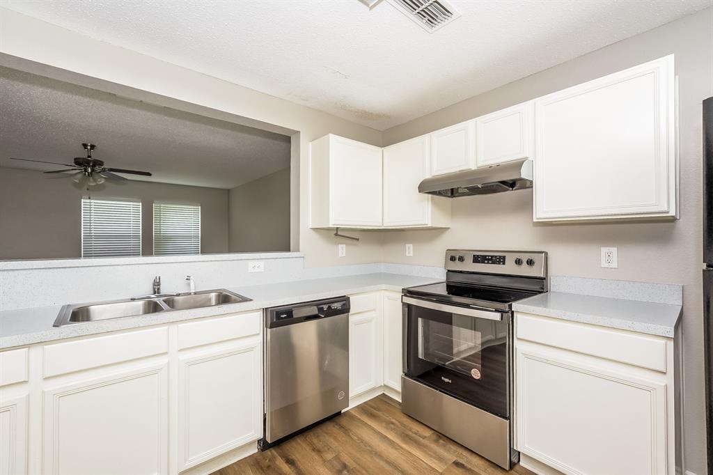 2553 Big Spring Drive Fort Worth, TX 76120 - Photo 6 of 15 a kitchen with a stove microwave and cabinets