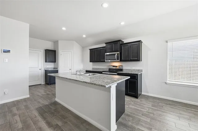 a kitchen with a sink stove and refrigerator