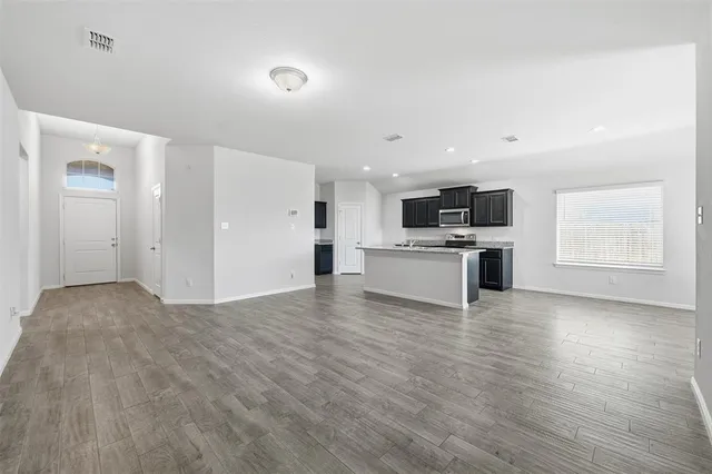 a view of kitchen with microwave and wooden floor