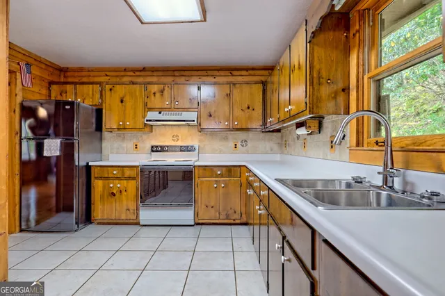 a kitchen with stainless steel appliances granite countertop a sink and cabinets