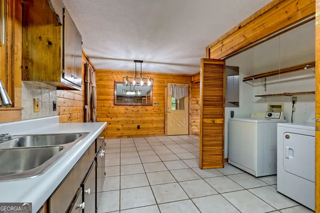 a kitchen with stainless steel appliances a sink window and cabinets