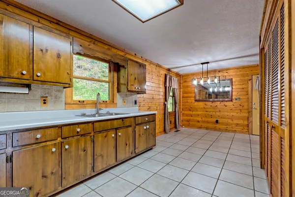 a kitchen with stainless steel appliances granite countertop a sink and a stove
