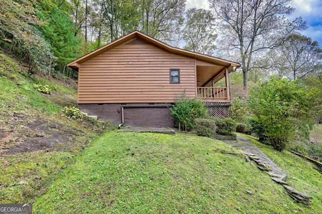 an aerial view of a house with a yard