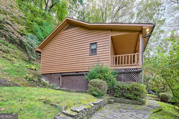 a backyard of a house with lots of green space and garden