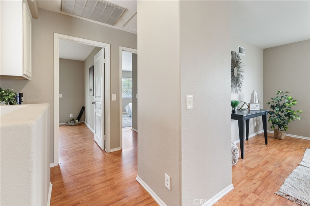 1263 Date Palm Drive Carson, CA 90746 - Photo 30 of 41 a view of a hallway with wooden floor and a living room