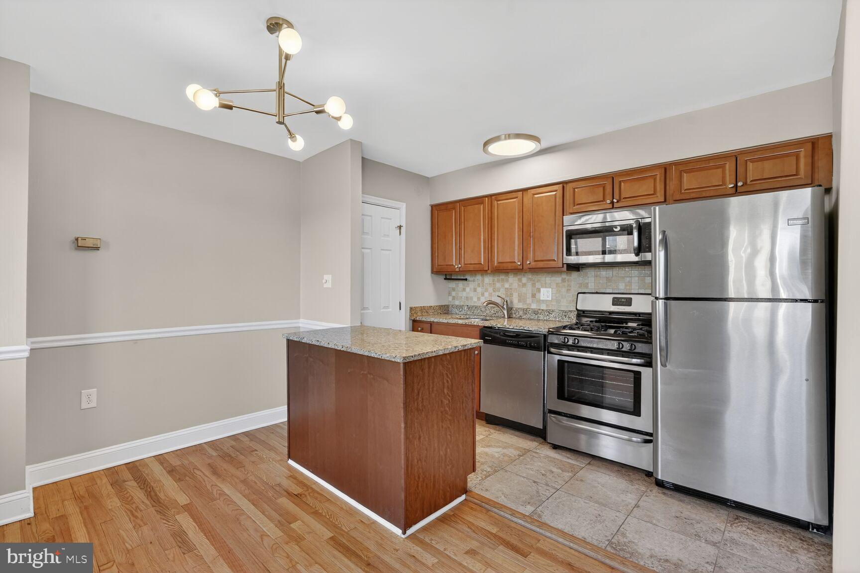 1200 South Arlington Ridge Road, Unit 504 Arlington, VA 22202 - Photo 2 of 15 a kitchen with stainless steel appliances a refrigerator and a stove top oven