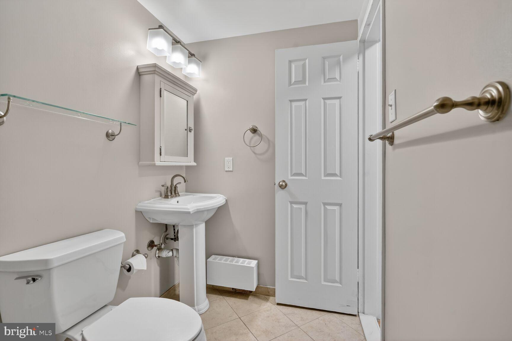 1200 South Arlington Ridge Road, Unit 504 Arlington, VA 22202 - Photo 10 of 15 a bathroom with a sink a toilet and shower