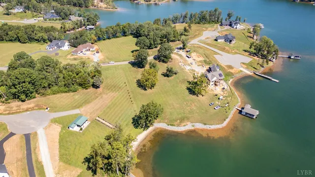 an aerial view of residential house with swimming pool and lawn chairs