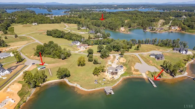an aerial view of a house with a lake view