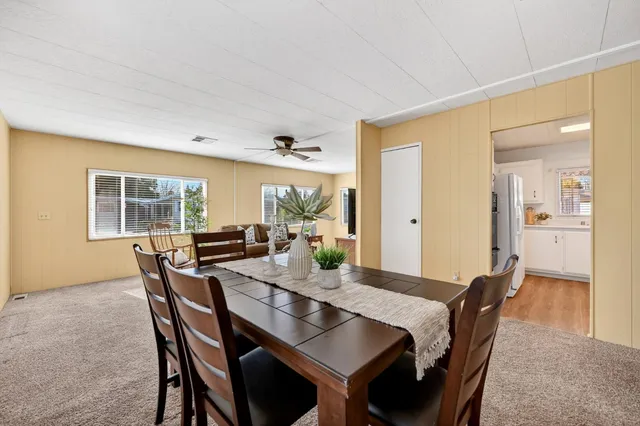 a view of a dining room with furniture and window
