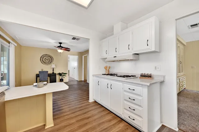 a kitchen with a stove a sink and a refrigerator