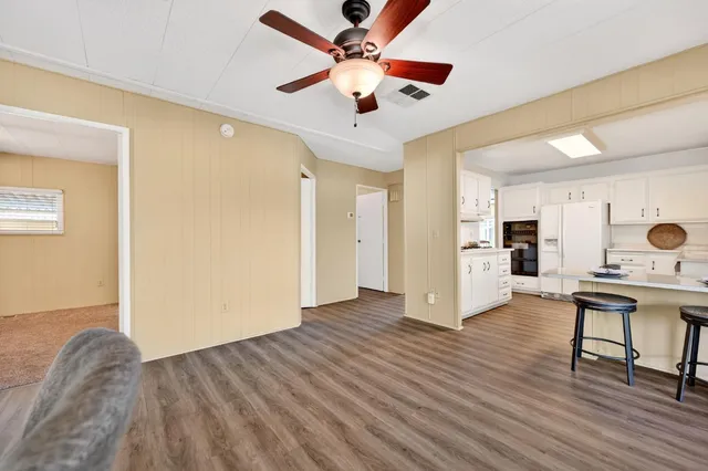a view of workspace with wooden floor and ceiling fan