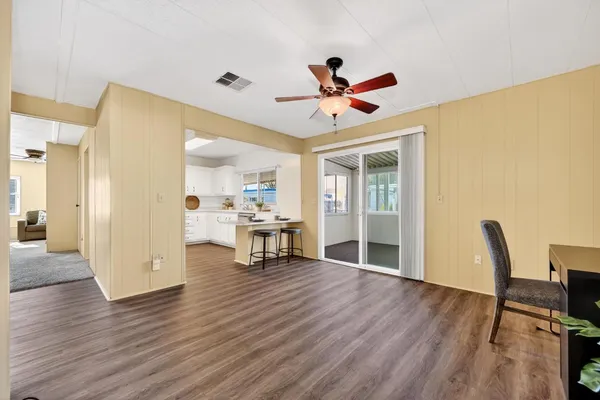 a view of a livingroom with furniture and a ceiling fan