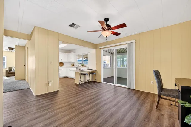 a view of a livingroom with furniture and a ceiling fan