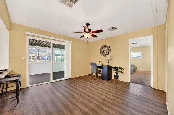 a view of a livingroom with furniture and a ceiling fan