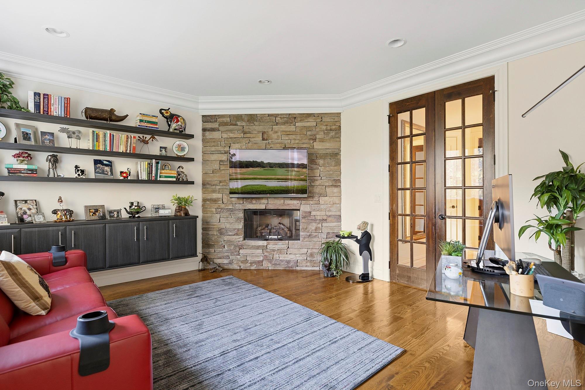 144 Round Swamp Road West Hills, NY 11743 - Photo 26 of 39 Living room featuring wood finished floors, crown molding, a fireplace, and french doors