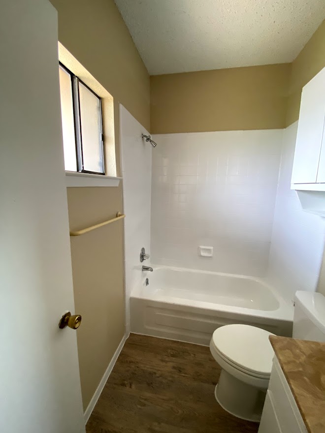 3316 Guadalupe Street, Unit 212 Austin, TX 78705 - Photo 12 of 22 a bathroom with a toilet and a bathtub