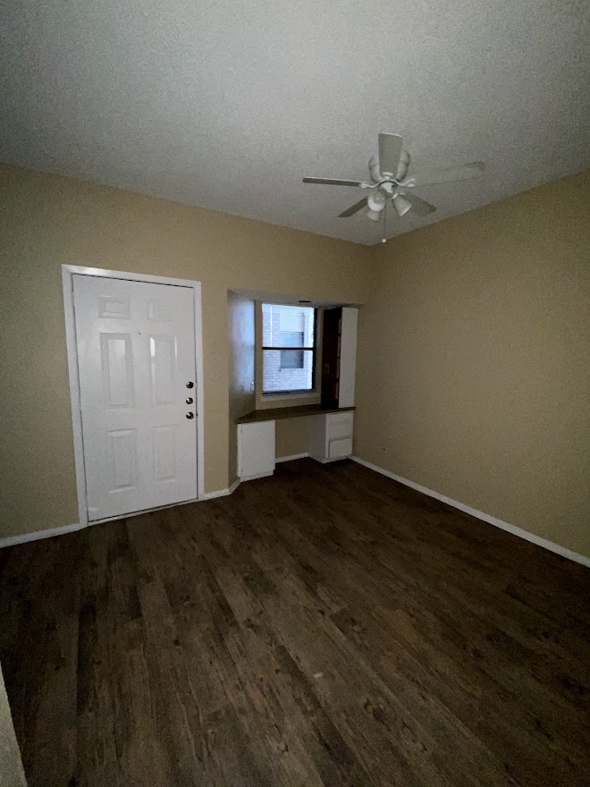 3316 Guadalupe Street, Unit 212 Austin, TX 78705 - Photo 6 of 22 an empty room with wooden floor cabinet and windows