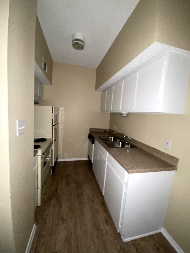 3316 Guadalupe Street, Unit 212 Austin, TX 78705 - Photo 8 of 22 a kitchen with a sink stove and refrigerator