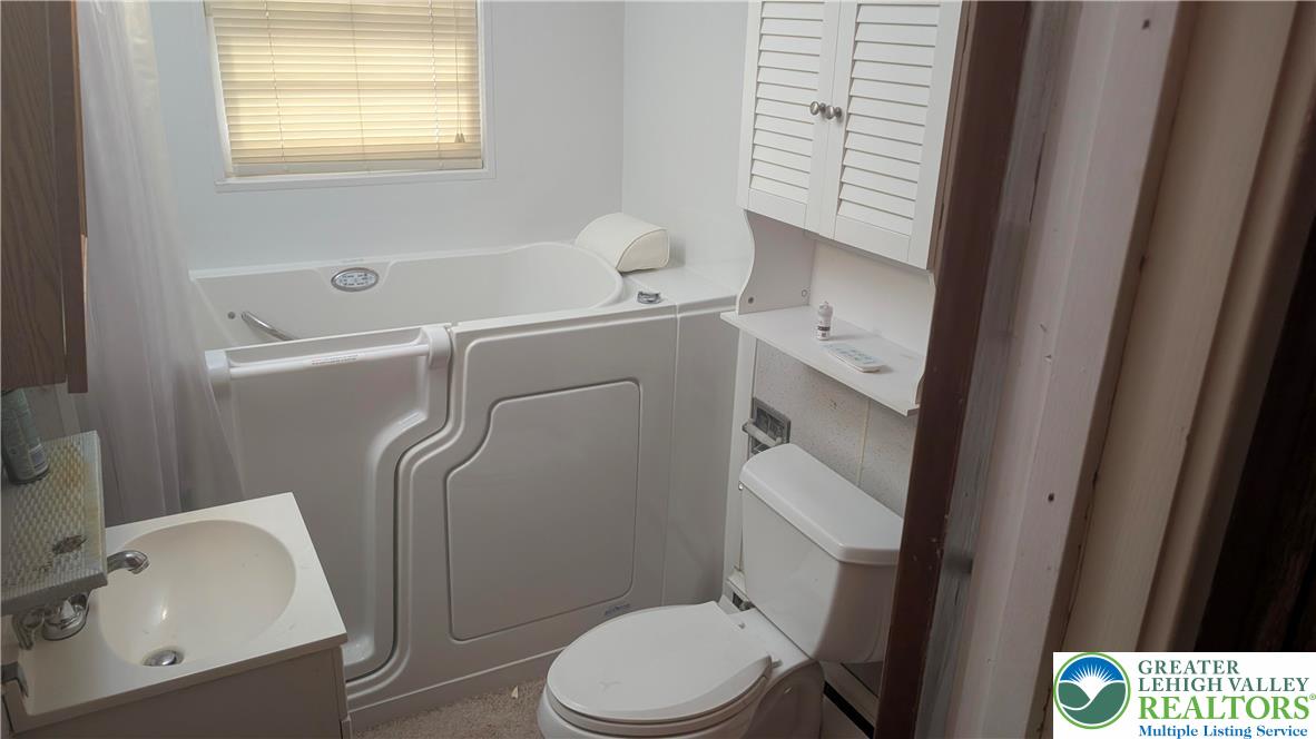 744 South Dogwood Road Walnutport, PA 18088 - Photo 5 of 10 a white toilet sitting next to a bathroom sink