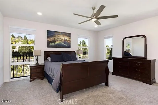 a spacious bedroom with a bed and a window