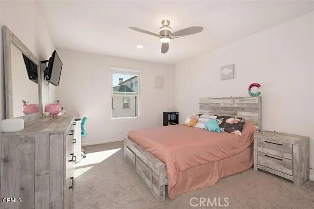 a view of a workspace with furniture and a flat screen tv