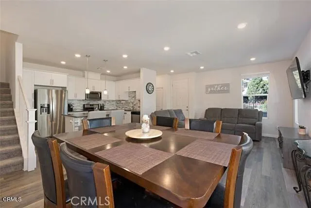 a kitchen with stainless steel appliances granite countertop a sink a stove and microwave