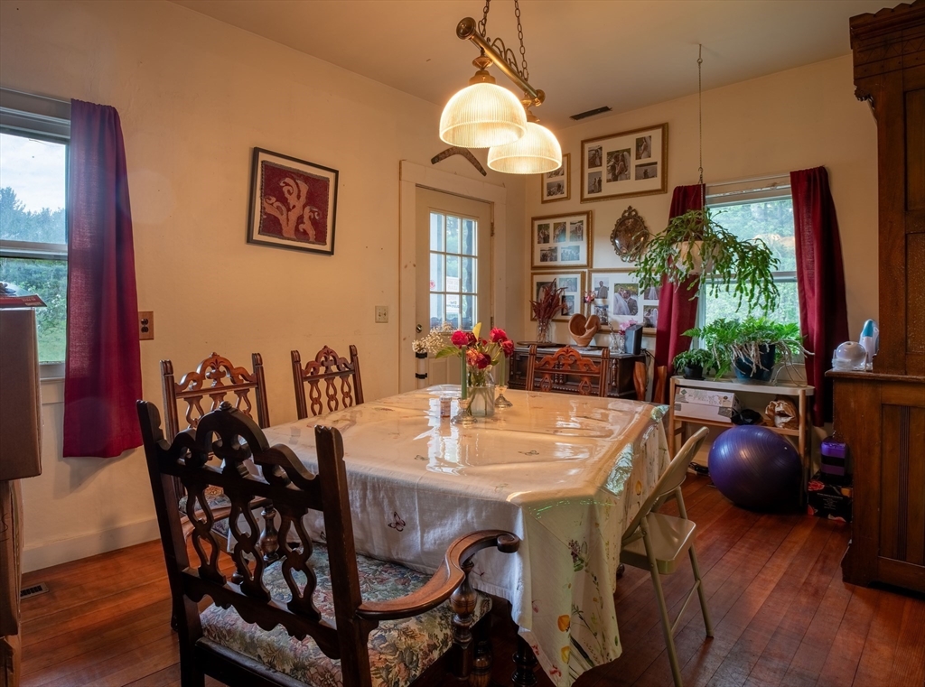 425 Dingle Road Worthington, MA 01098 - Photo 11 of 32 a view of a dining room with furniture a chandelier and wooden floor