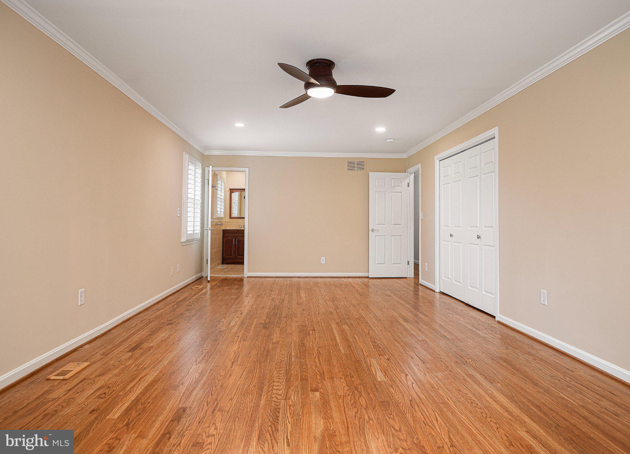 14300 Carroll Ridge Court Baldwin, MD 21013 - Photo 30 of 73 a view of an empty room with wooden floor and a ceiling fan
