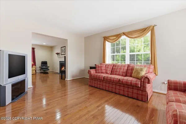 a living room with furniture a table and a chandelier