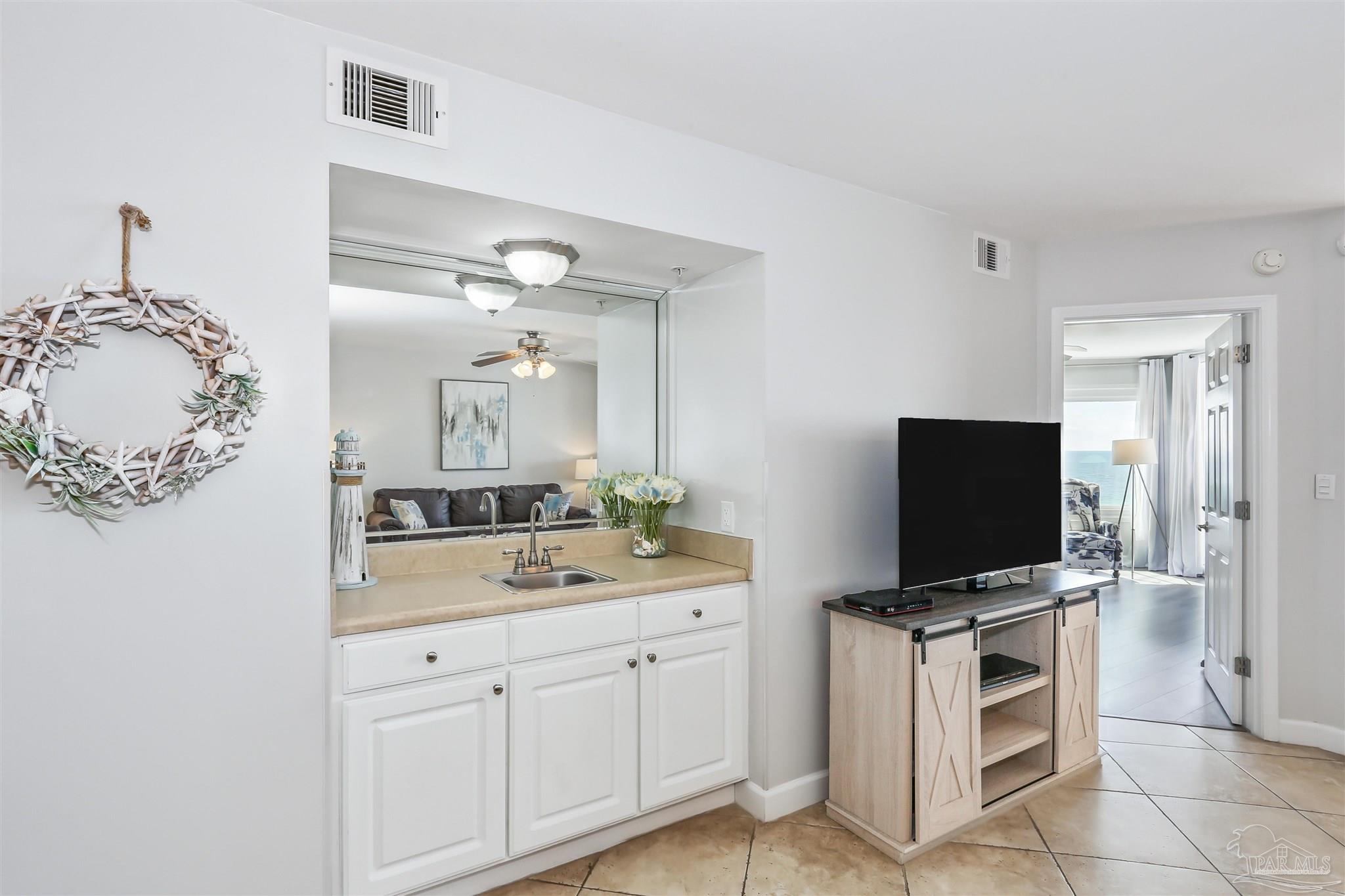 16285 Perdido Key Drive, Unit 424 Pensacola, FL 32507 - Photo 12 of 53 a spacious bathroom with a sink and a mirror