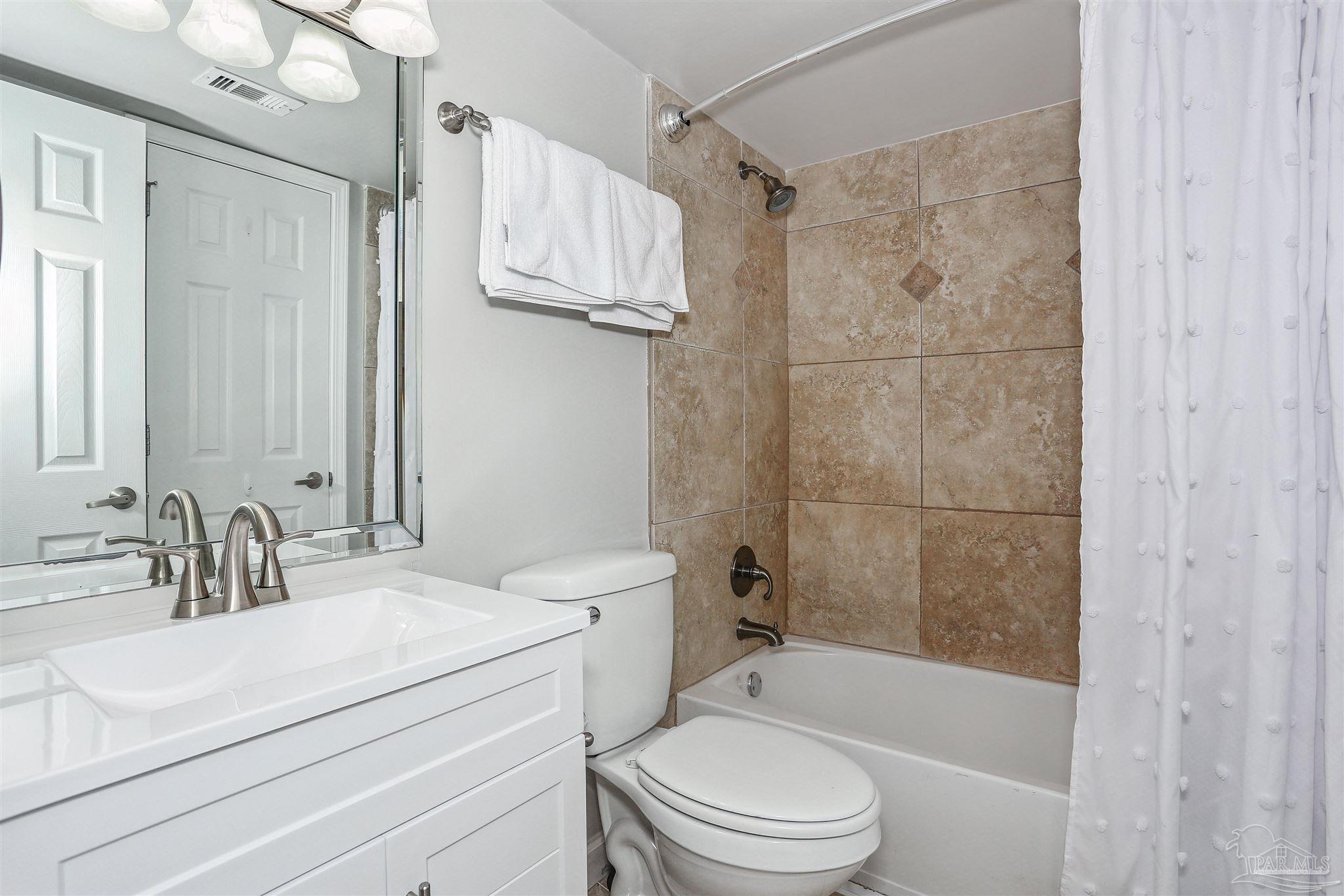 16285 Perdido Key Drive, Unit 424 Pensacola, FL 32507 - Photo 14 of 53 a bathroom with a sink a toilet and shower