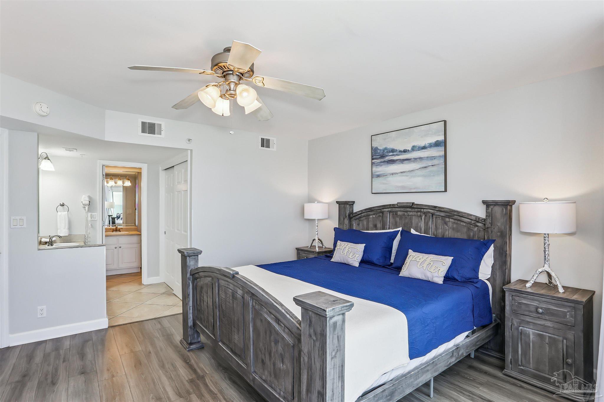 16285 Perdido Key Drive, Unit 424 Pensacola, FL 32507 - Photo 24 of 53 a bedroom with a bed and a chandelier