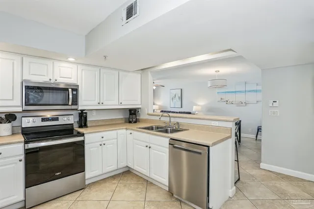 a kitchen with a stove sink and cabinets