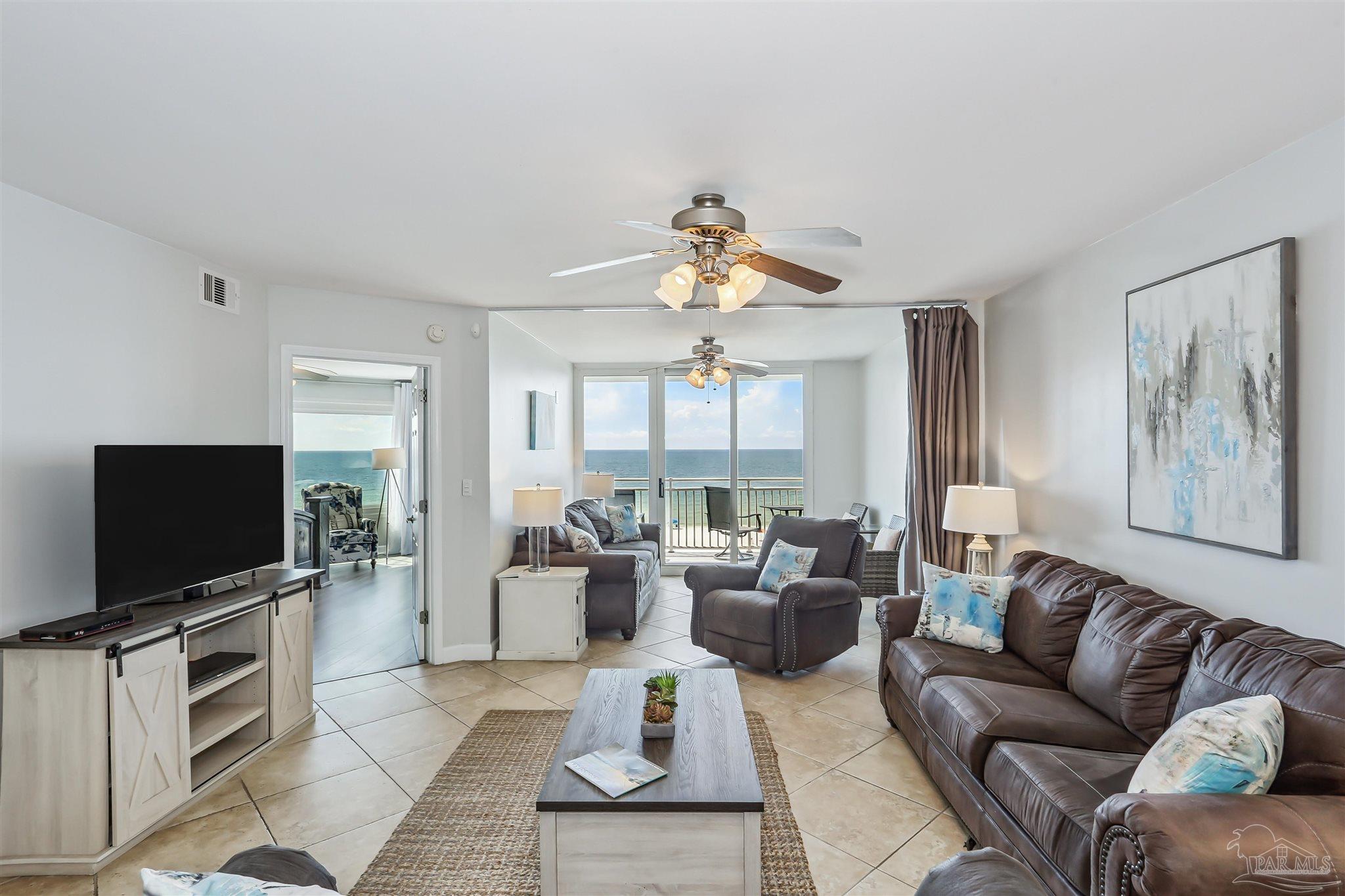 16285 Perdido Key Drive, Unit 424 Pensacola, FL 32507 - Photo 5 of 53 a living room with furniture and a flat screen tv