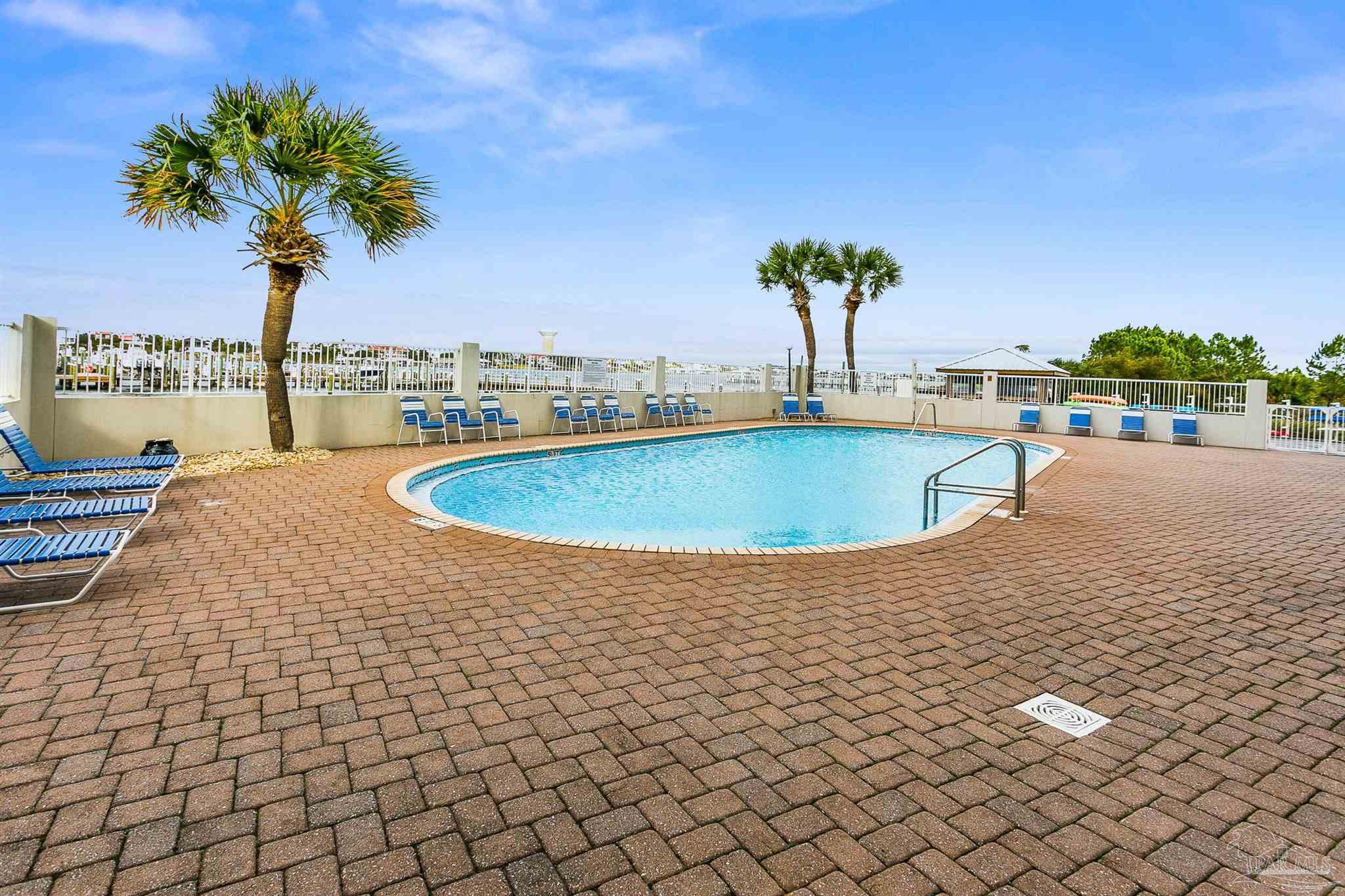 16285 Perdido Key Drive, Unit 424 Pensacola, FL 32507 - Photo 51 of 53 a view of a swimming pool with a yard
