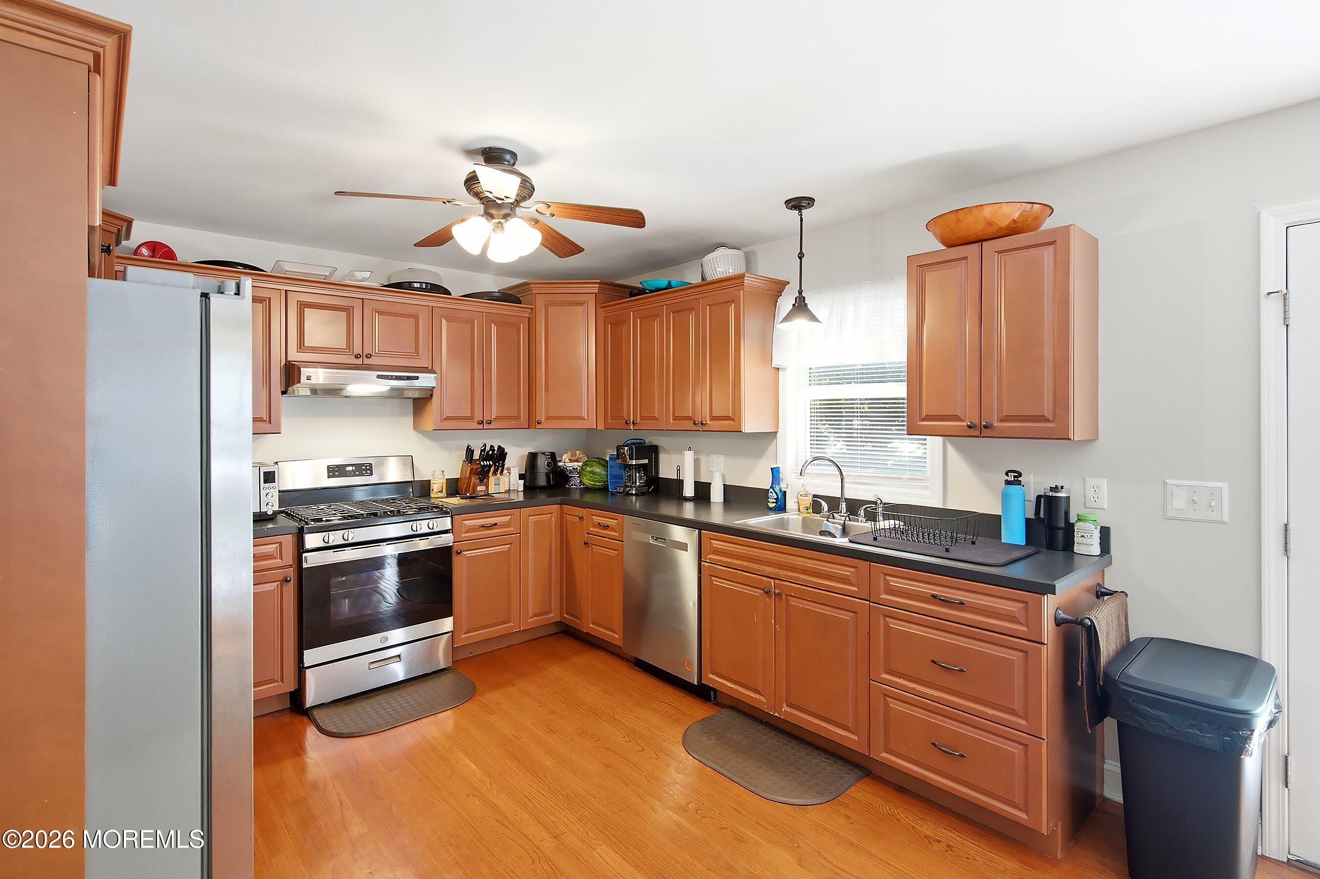 935 Bethel Church Road Jackson, NJ 08527 - Photo 11 of 32 a kitchen with stainless steel appliances granite countertop a stove sink and cabinets