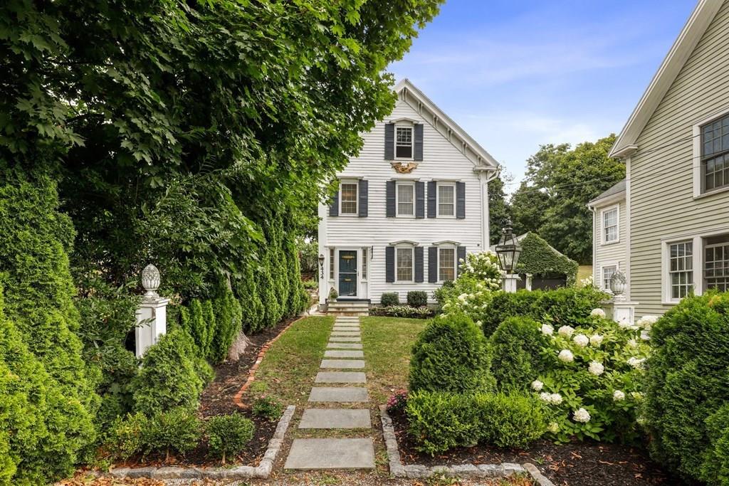434 Main Street Amesbury, MA 01913 - Photo 1 of 40 a front view of a house with a yard and potted plants