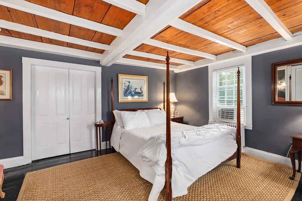 434 Main Street Amesbury, MA 01913 - Photo 19 of 40 a bedroom with a bed and a mirror