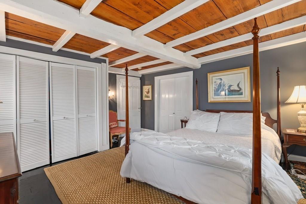 434 Main Street Amesbury, MA 01913 - Photo 20 of 40 a bedroom with a large bed and a large mirror