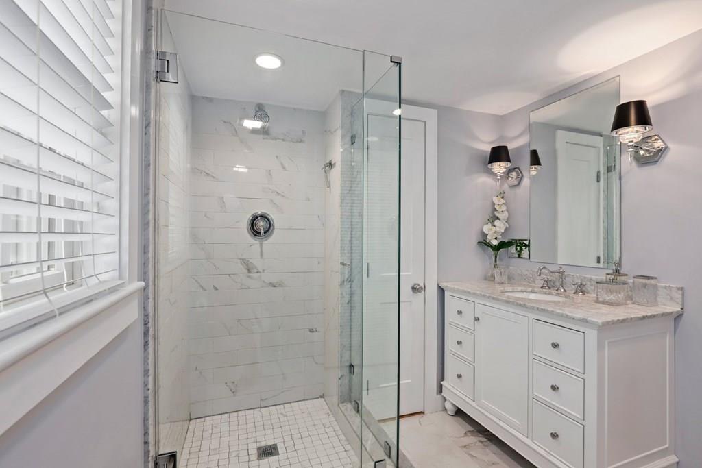 434 Main Street Amesbury, MA 01913 - Photo 21 of 40 a bathroom with a shower sink and mirror