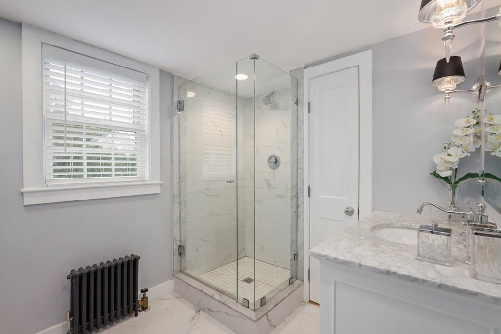434 Main Street Amesbury, MA 01913 - Photo 22 of 40 a bathroom with a granite countertop sink a mirror and shower