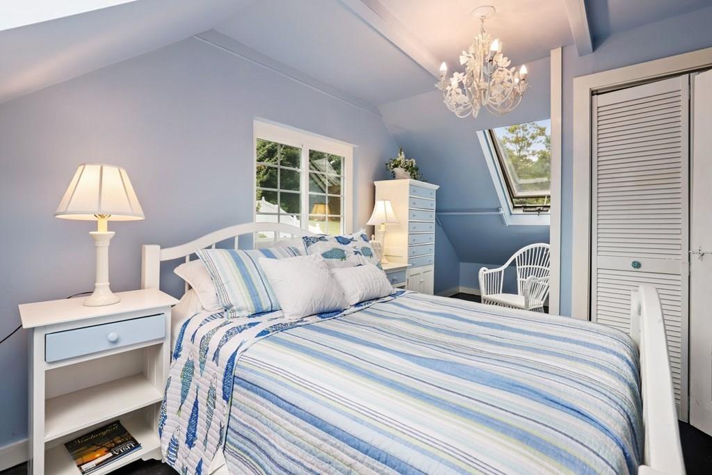 434 Main Street Amesbury, MA 01913 - Photo 25 of 40 a bedroom with a bed and a chandelier