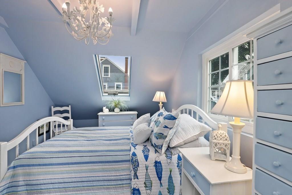 434 Main Street Amesbury, MA 01913 - Photo 26 of 40 a bedroom with furniture and a chandelier