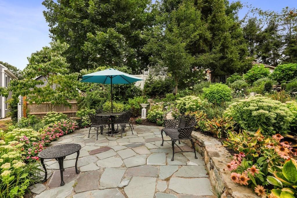 434 Main Street Amesbury, MA 01913 - Photo 30 of 40 a view of a table and chairs under an umbrella in backyard