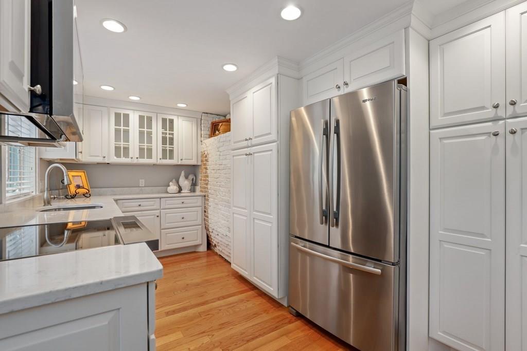 434 Main Street Amesbury, MA 01913 - Photo 3 of 40 a kitchen with stainless steel appliances a refrigerator stove and sink