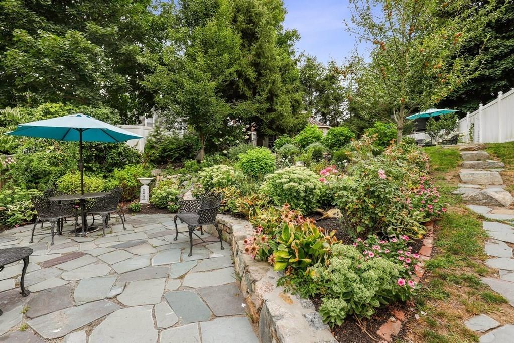 434 Main Street Amesbury, MA 01913 - Photo 32 of 40 a view of a patio with table and chairs under an umbrella