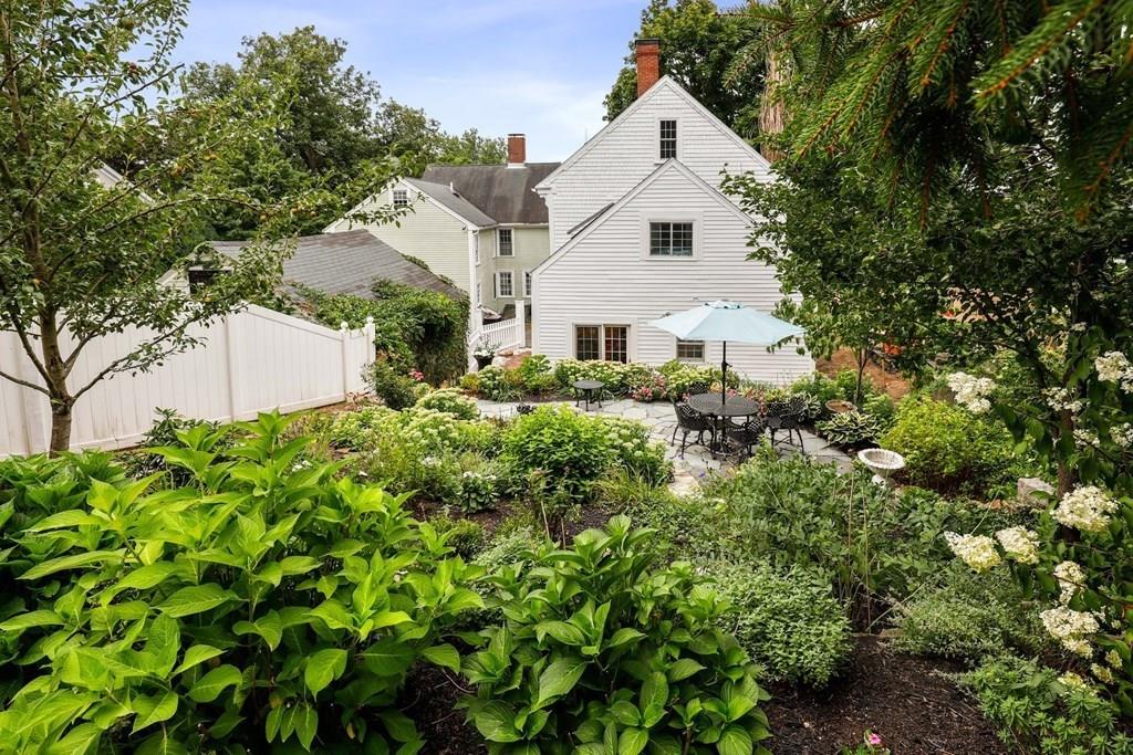 434 Main Street Amesbury, MA 01913 - Photo 34 of 40 a view of a white house with a tree and plants
