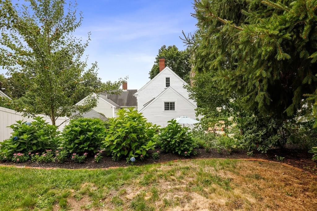 434 Main Street Amesbury, MA 01913 - Photo 35 of 40 a view of a white house with a yard and plants