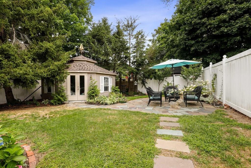 434 Main Street Amesbury, MA 01913 - Photo 36 of 40 a view of a patio with table and chairs under an umbrella